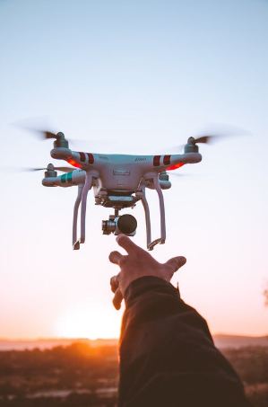 White and red quadcopter drone close up photography