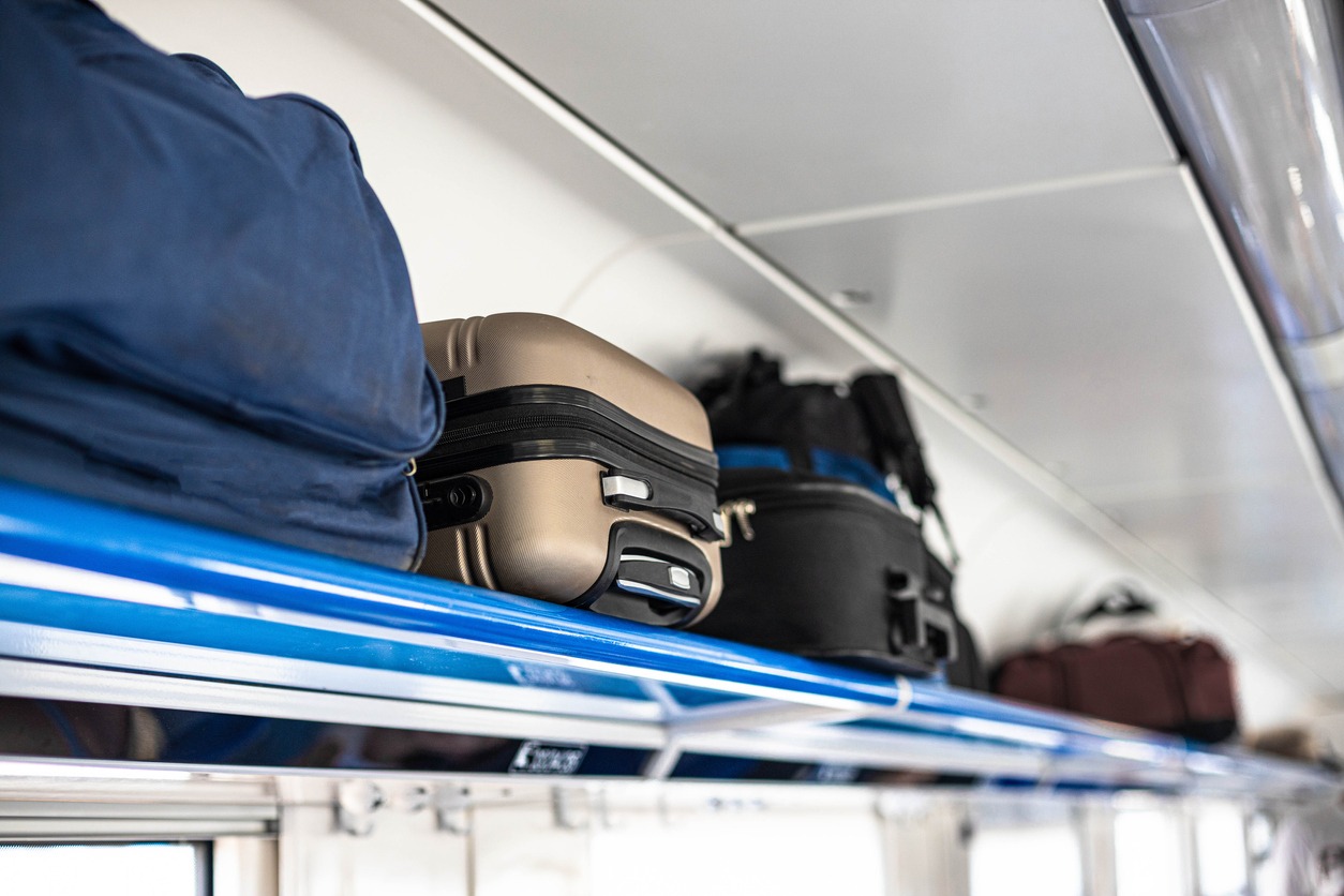 Bags and luggage on a shelf railway train