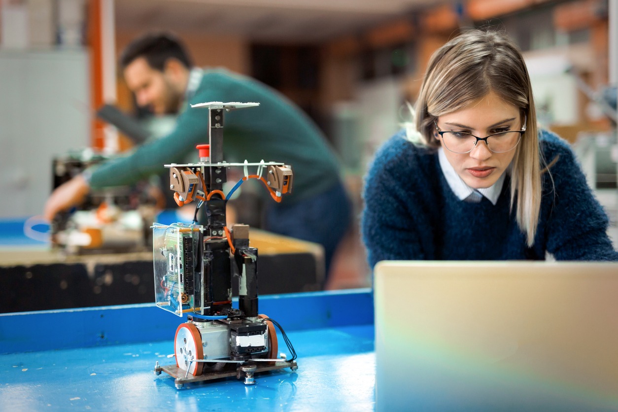 A young woman engineer working on a robotics project