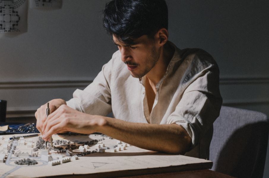 a guy working on an architectural model