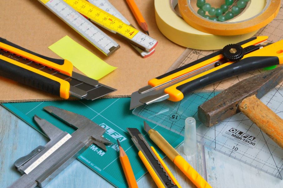 an assortment of cutters, blades, and rulers