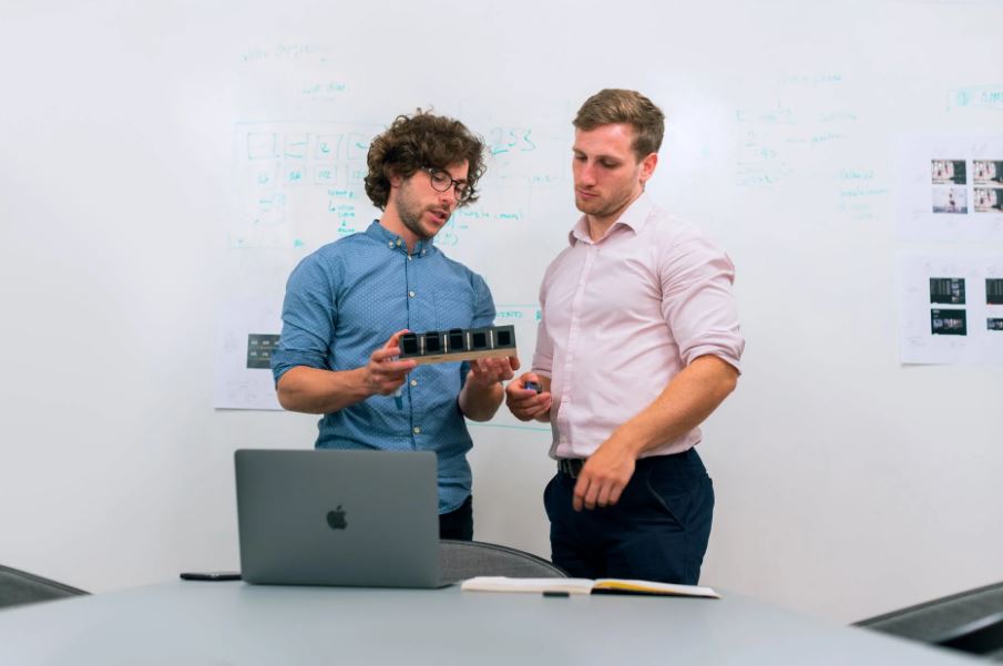 two men checking a prototype model
