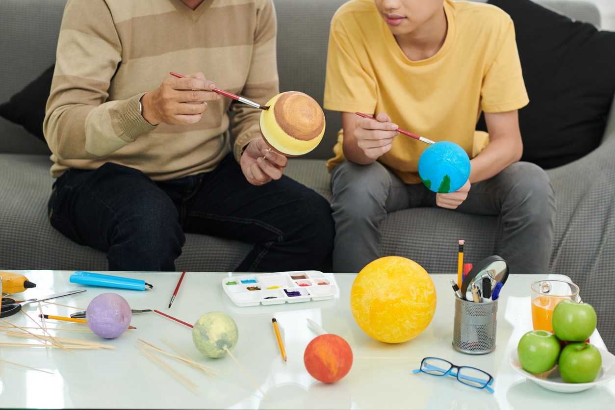 Father and Son Making Solar System Model