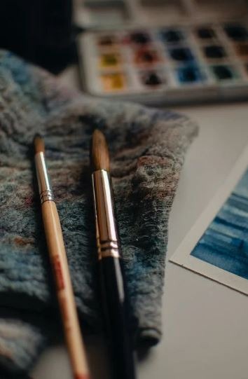 Various painting tools on a white table