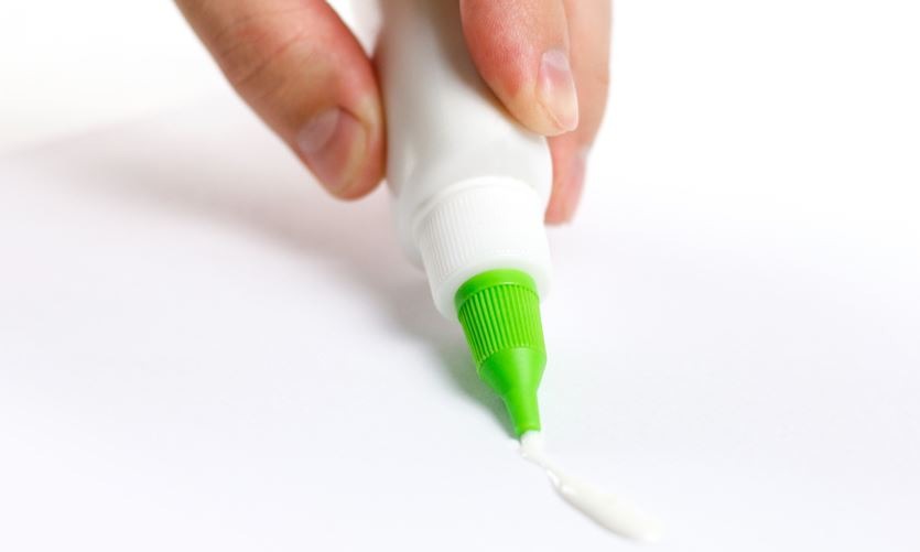 glue in a white bottle and green cap