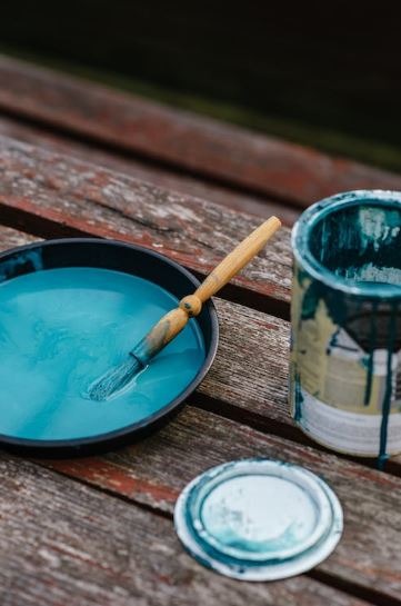 A bowl of paint near a jar