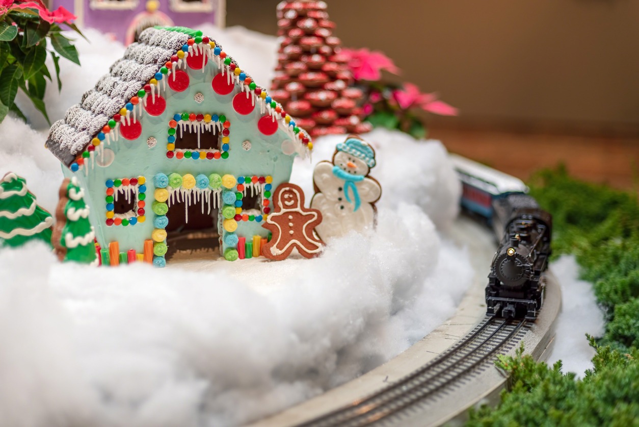 Holiday display with toy train and gingerbread house