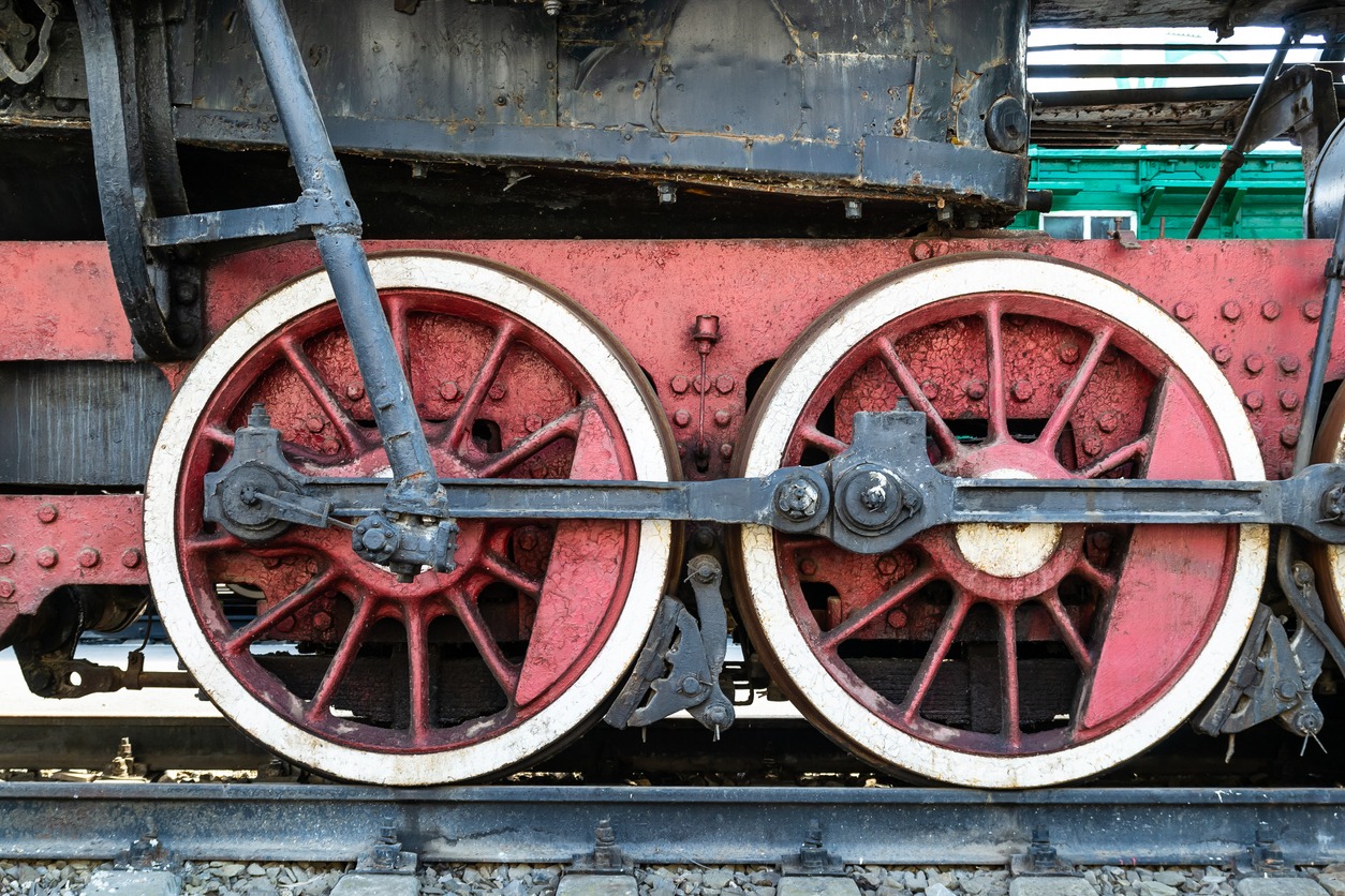 Wheels of the old locomotive of red color and the elements of the drive
