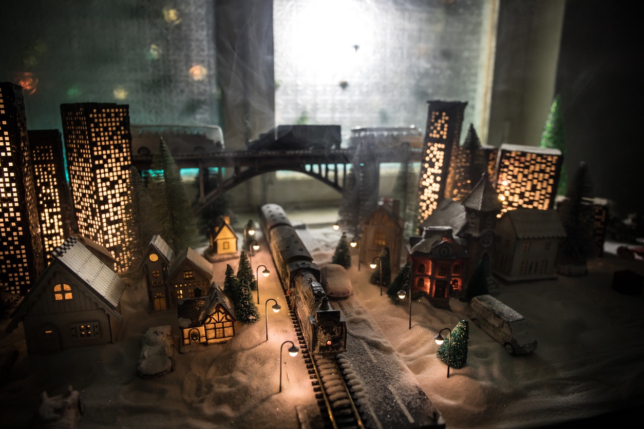 Miniature of winter scene with Christmas houses, train station, trees, covered in snow